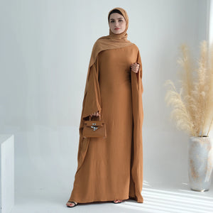 Camel batwing abaya styled with a scarf, front view