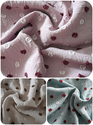 Close-up of raised dot texture in mauve, stone and aqua fabric