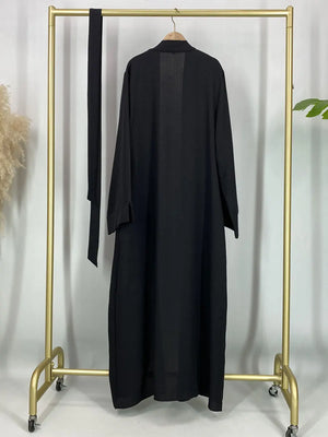Black open abaya displayed on a hanger