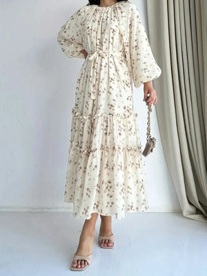 Cream floral long dress showing the coordinating waist tie