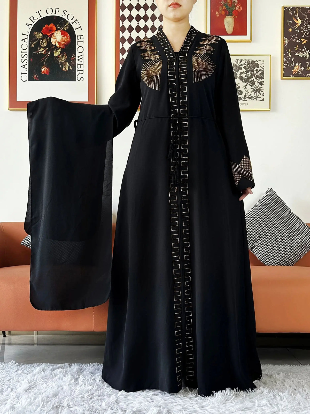 HIA Embellished Zip-Front Abaya — Black abaya with gold-toned detail, styled with scarf