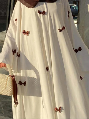 HIA Bow-Detail Flared-Sleeve Abaya — cream abaya with contrast bows