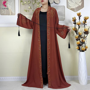 Rust Ornate abaya shown open over an inner layer