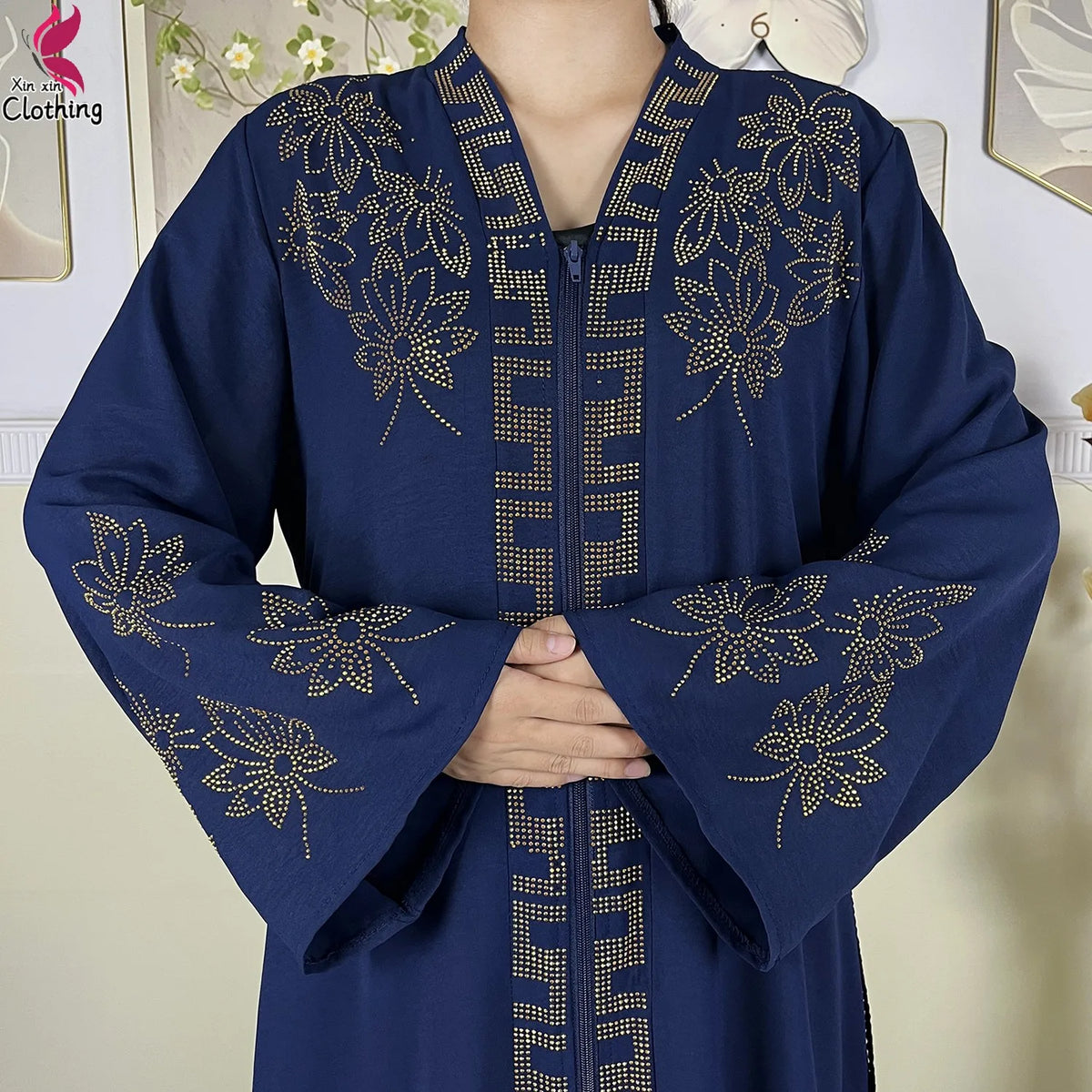 Close-up of the ornate neckline decoration on a navy abaya