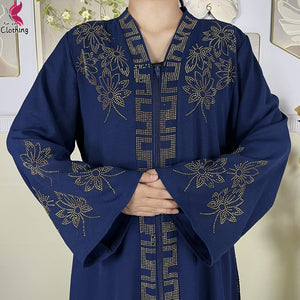 Close-up of the ornate neckline decoration on a navy abaya