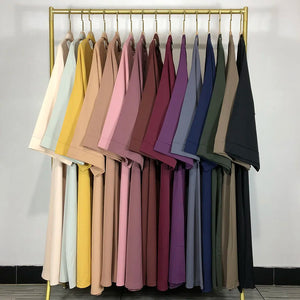 Classic Nida Belted Abaya colour range on a clothing rail