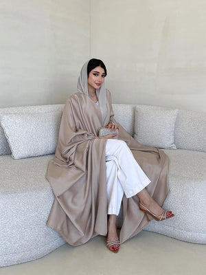 Alternate seated view showing the drape of the taupe open abaya