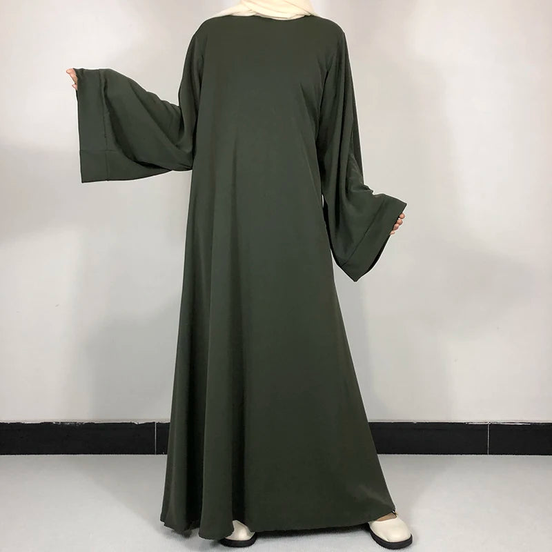 Army green Classic Nida Belted Abaya shown loose with wide sleeves