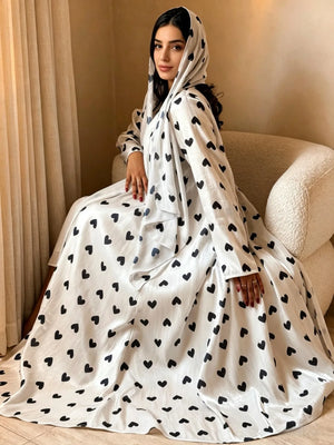 Heart Print Abaya & Hijab Set — White with Black Hearts seated view