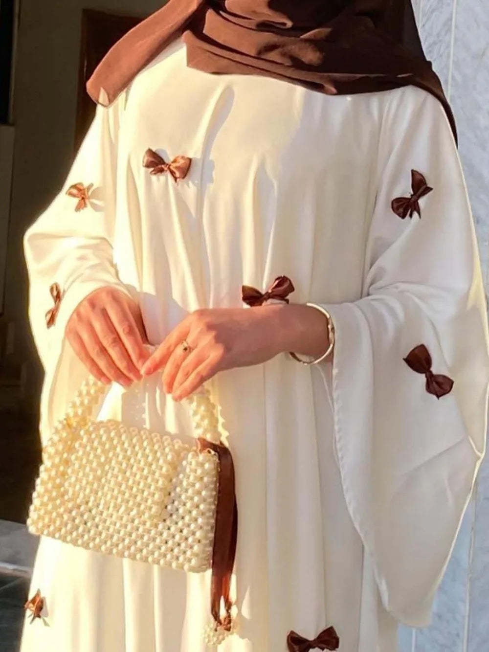 HIA Bow-Detail Flared-Sleeve Abaya — product styling and bow detail 2